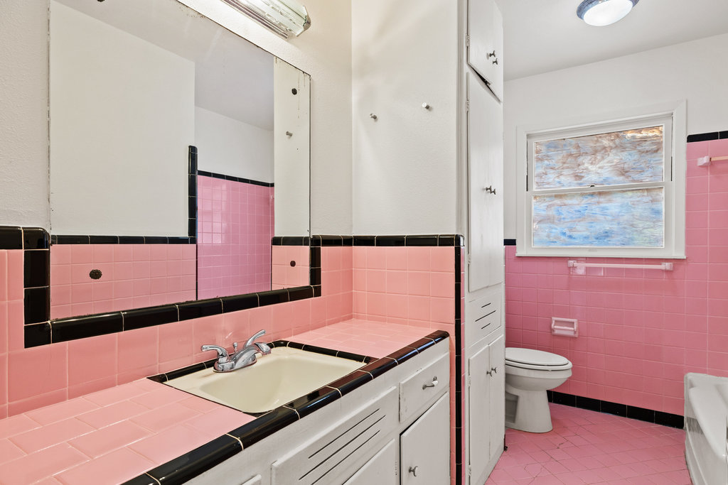 1502 Ridgehaven Drive Austin, TX 78723 - Photo 15 of 34 a bathroom with a granite countertop toilet sink and mirror