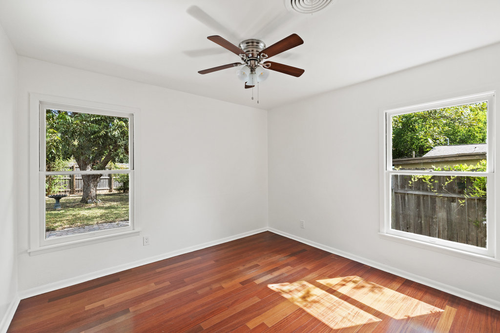 1502 Ridgehaven Drive Austin, TX 78723 - Photo 19 of 34 a view of empty room with wooden floor and fan