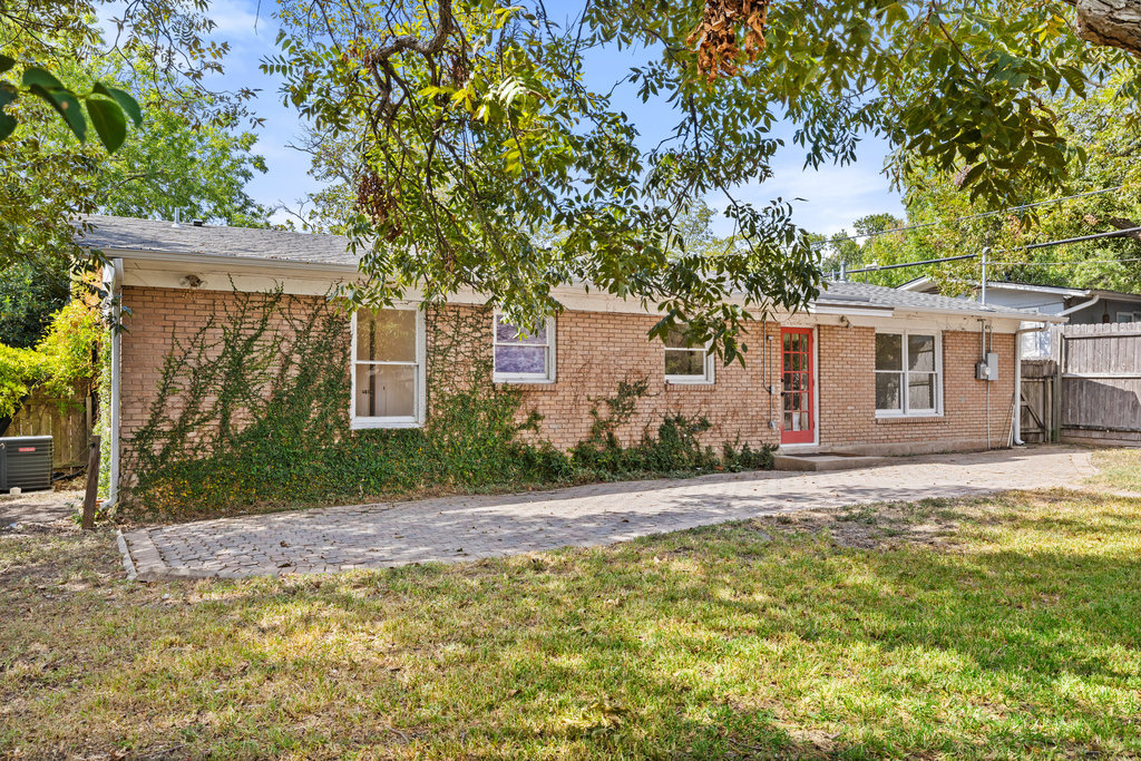 1502 Ridgehaven Drive Austin, TX 78723 - Photo 21 of 34 a front view of a house with a yard and garage