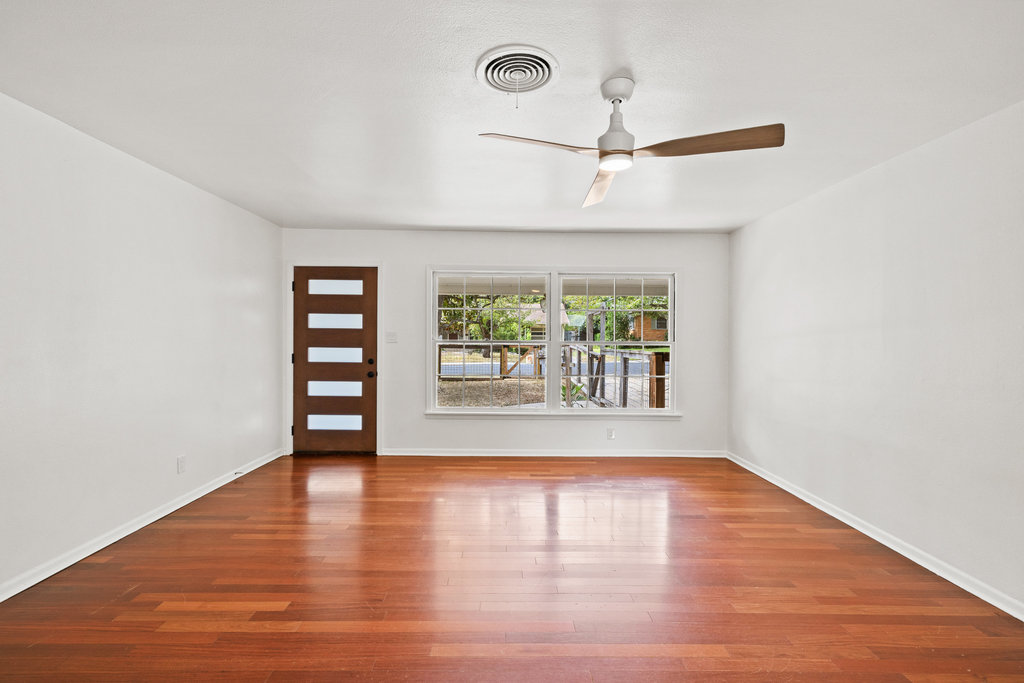 1502 Ridgehaven Drive Austin, TX 78723 - Photo 24 of 34 a view of an empty room with wooden floor and a window
