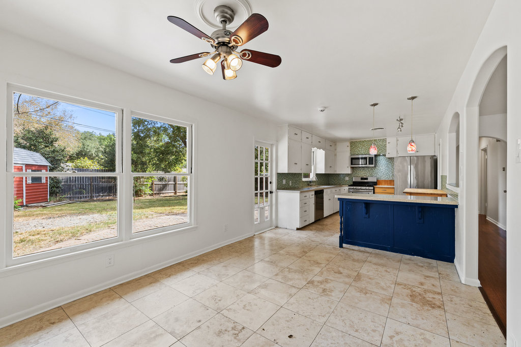 1502 Ridgehaven Drive Austin, TX 78723 - Photo 31 of 34 a view of kitchen with kitchen island wooden floor center island and stainless steel appliances