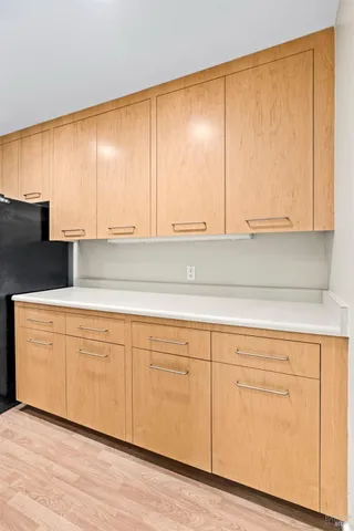 a kitchen with granite countertop white cabinets and sink