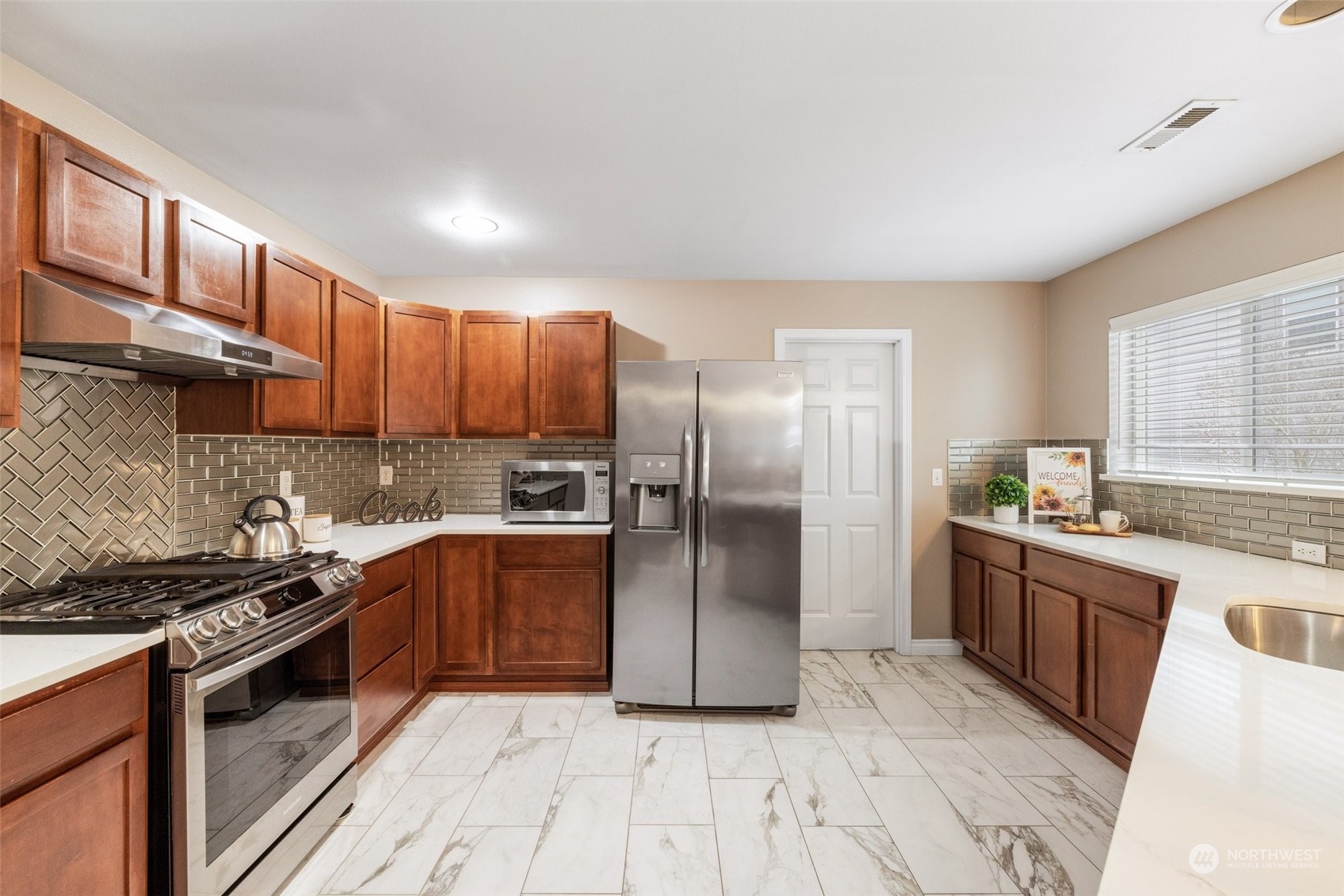 3500 154th Place Southeast Bothell, WA 98012 - Photo 16 of 36 a kitchen with stainless steel appliances granite countertop a stove a sink dishwasher a refrigerator and cabinets with wooden floor