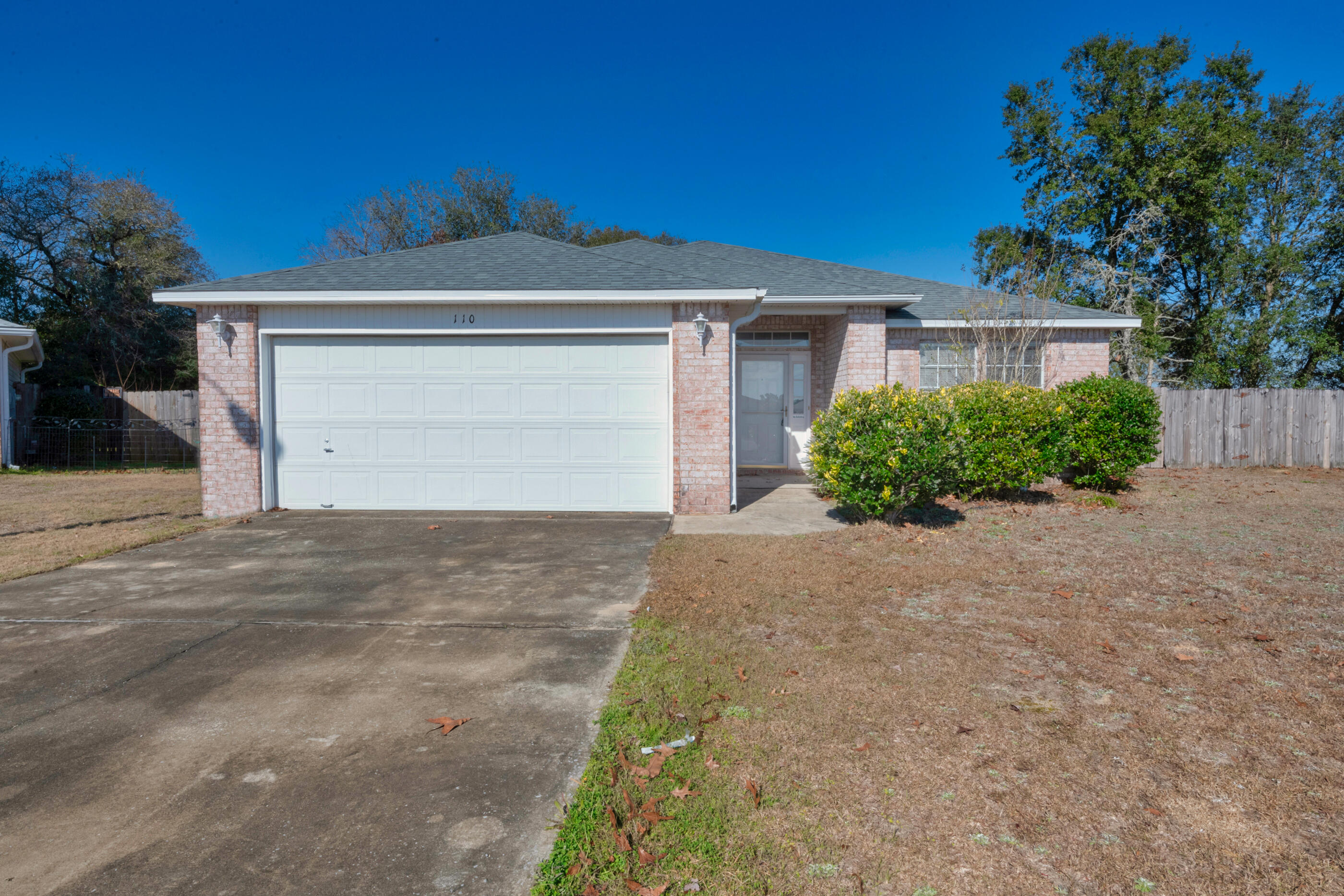 110 Sandstone Trail Crestview, FL 32539 - Photo 1 of 25 a front view of a house with a yard and garage