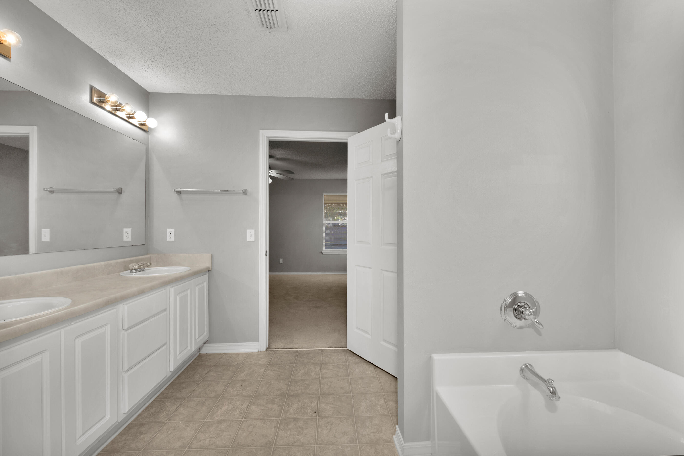 110 Sandstone Trail Crestview, FL 32539 - Photo 15 of 25 a bathroom with a tub sink and mirror