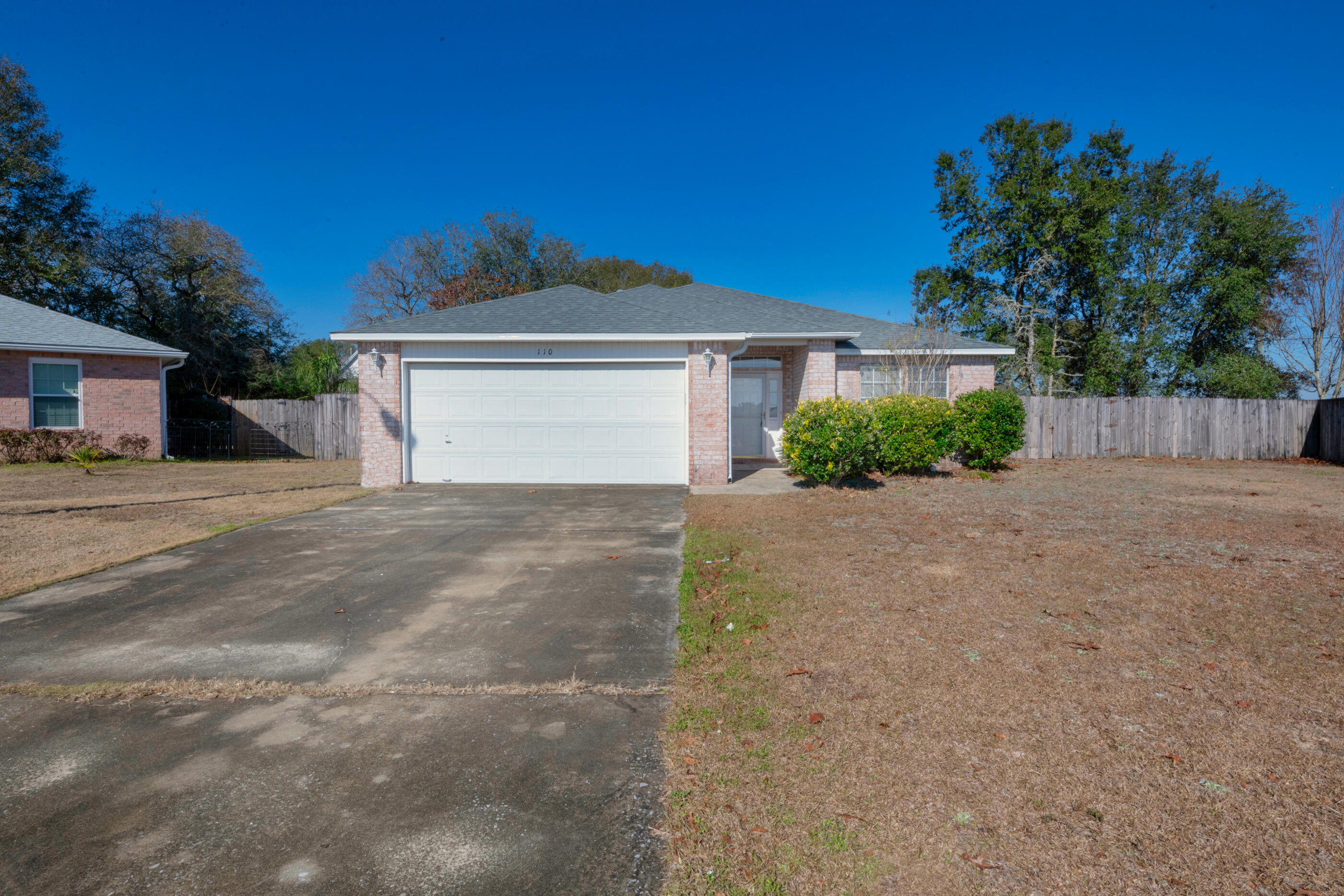 110 Sandstone Trail Crestview, FL 32539 - Photo 2 of 25 a front view of a house with a yard and garage