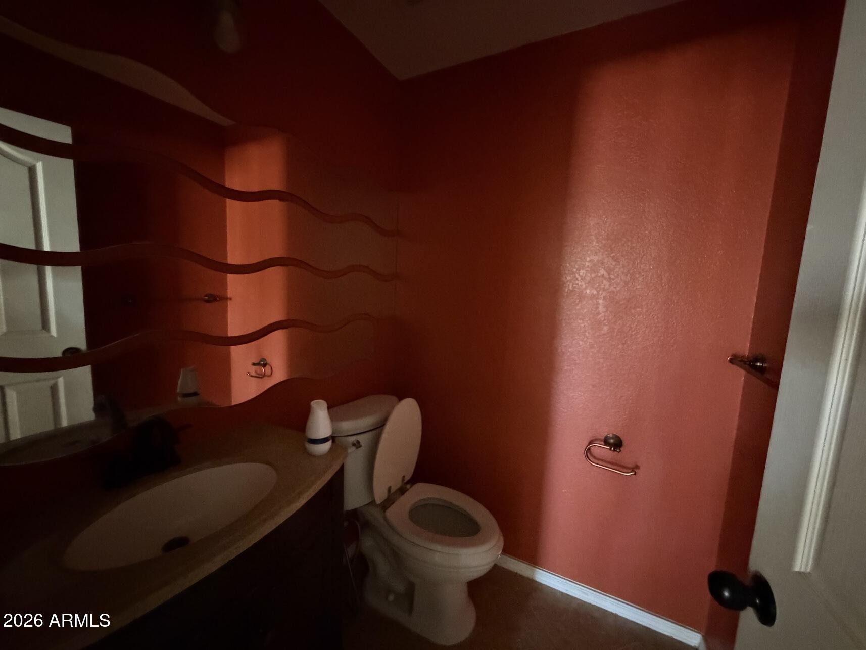 10807 West Monte Vista Road Avondale, AZ 85392 - Photo 16 of 33 a bathroom with a toilet and a sink