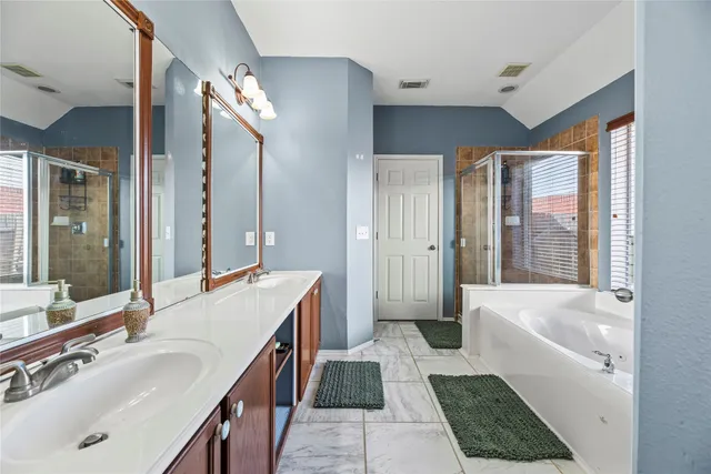 a bathroom with a tub sink and mirror
