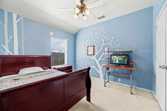 a bedroom with a bed and a table in it