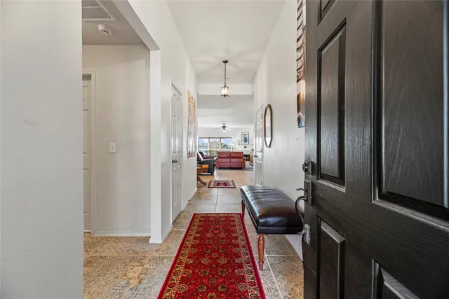 a hallway with a view of living room