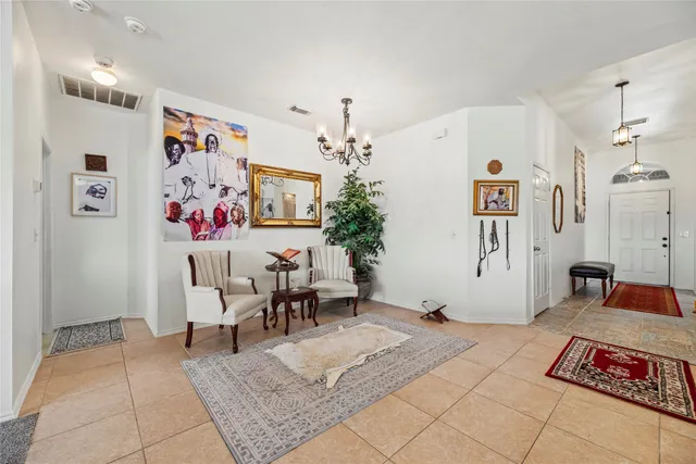 a living room with furniture and a chandelier