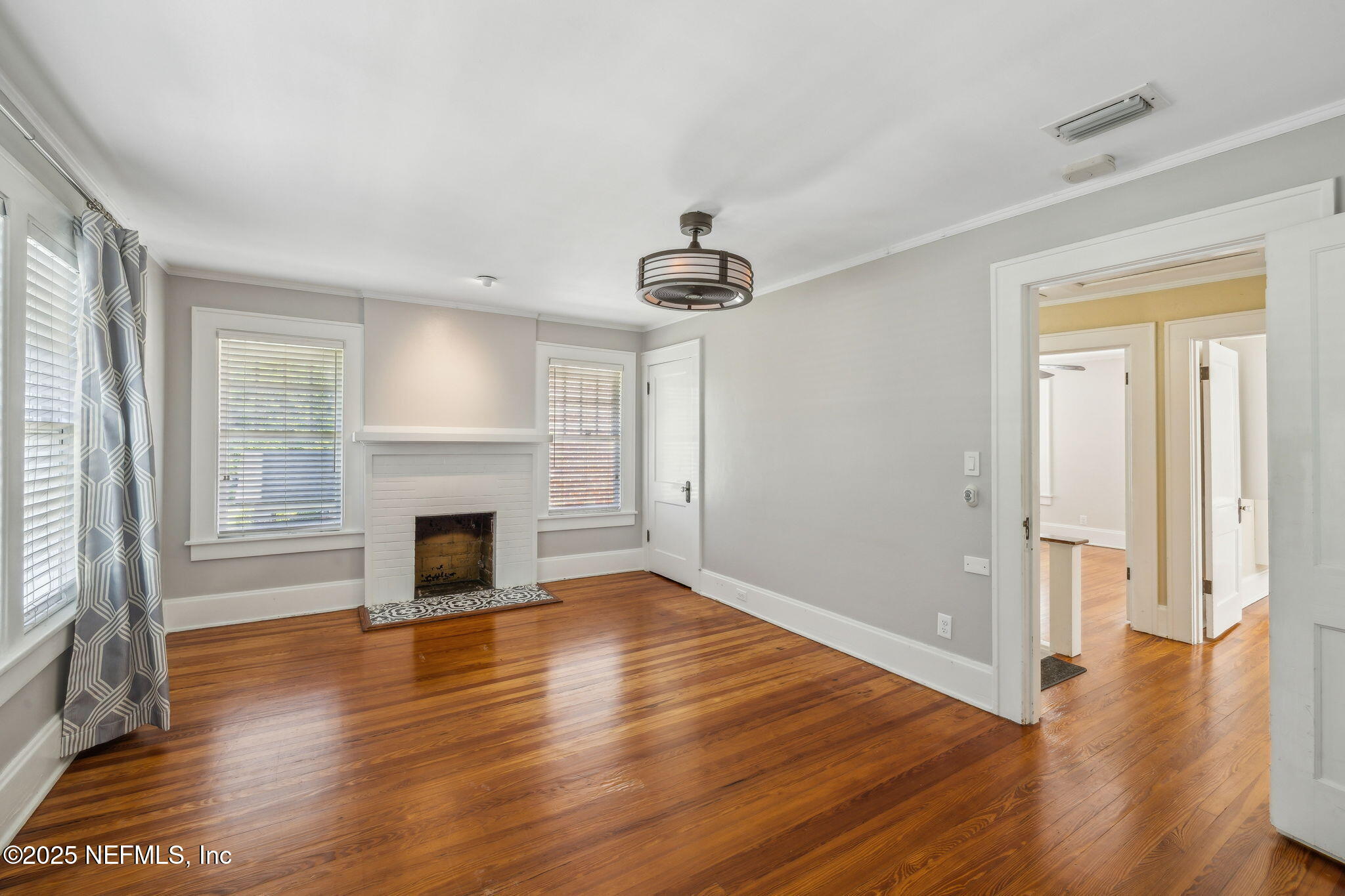 1361 Challen Avenue Jacksonville, FL 32205 - Photo 20 of 45 an empty room with wooden floor a fireplace and windows
