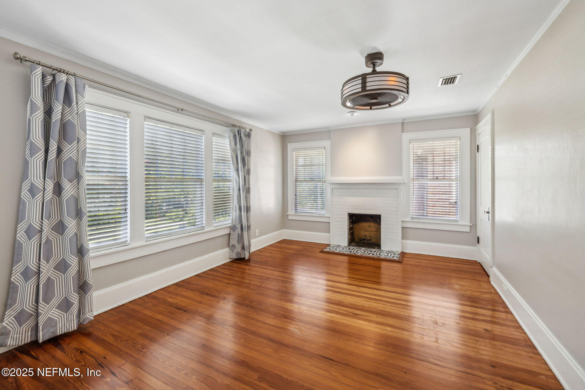 1361 Challen Avenue Jacksonville, FL 32205 - Photo 21 of 45 a view of an empty room with wooden floor fireplace and a window