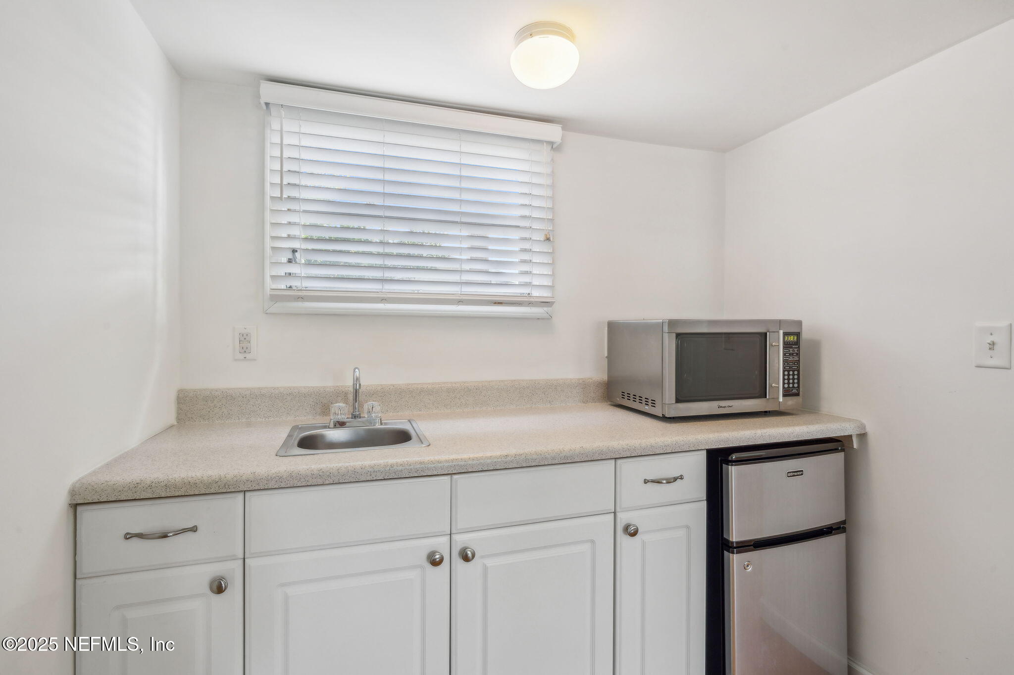 1361 Challen Avenue Jacksonville, FL 32205 - Photo 37 of 45 a kitchen with a sink and a microwave