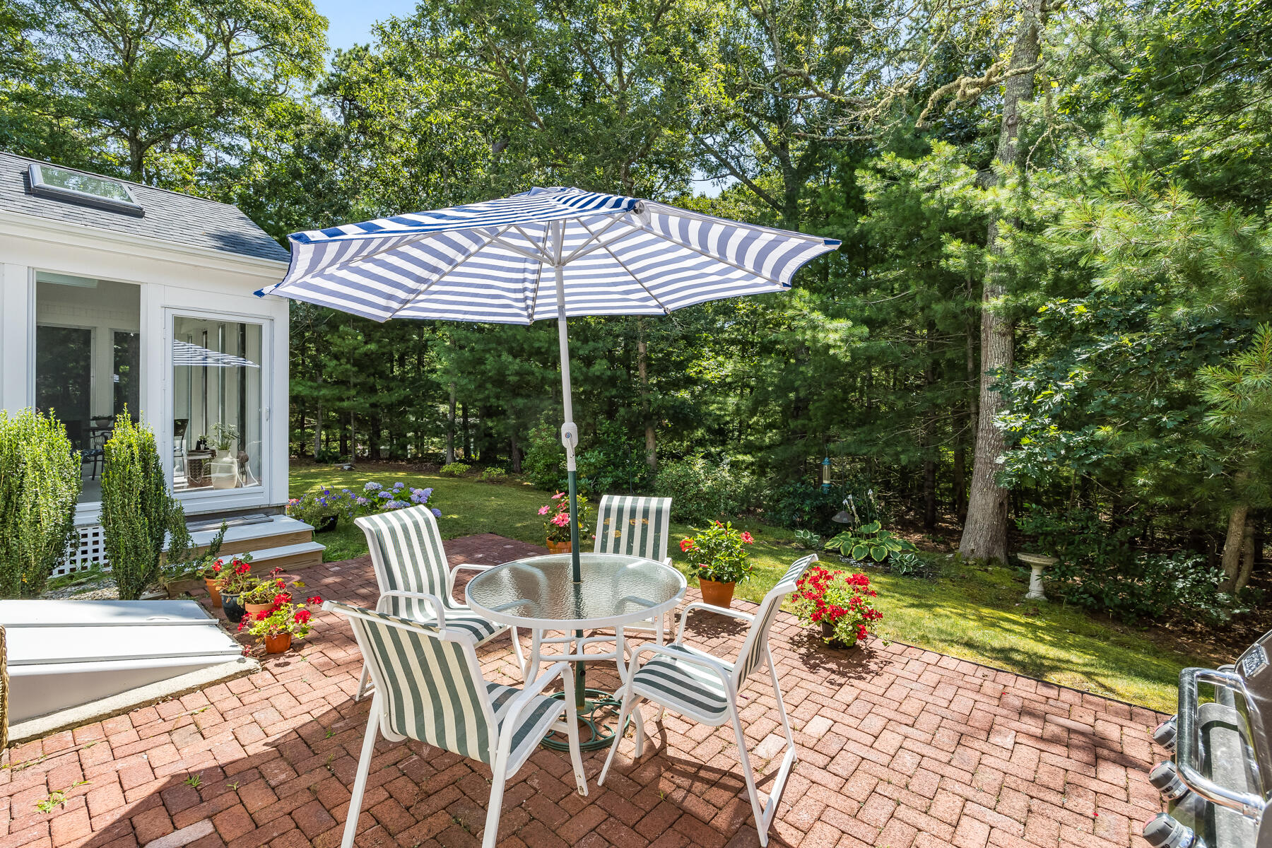 17 Cres Ridge Way Orleans, MA 02653 - Photo 31 of 40 a view of a patio with a table chairs and a floor to ceiling window