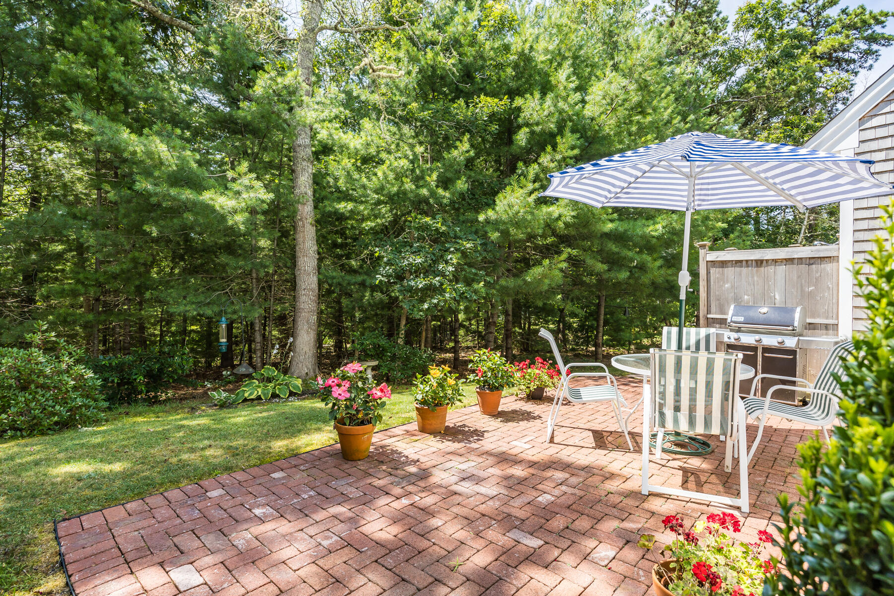 17 Cres Ridge Way Orleans, MA 02653 - Photo 33 of 40 a view of a table and chairs under an umbrella