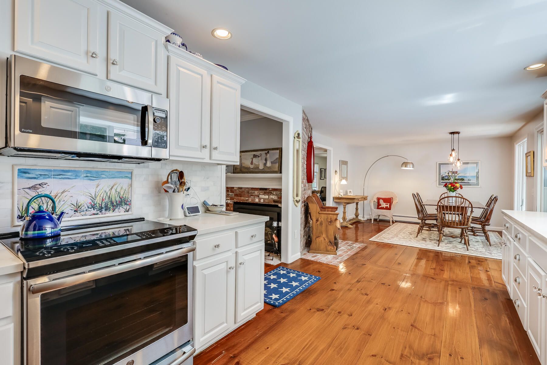 17 Cres Ridge Way Orleans, MA 02653 - Photo 10 of 40 a kitchen with stainless steel appliances a stove a sink cabinets and a wooden floor