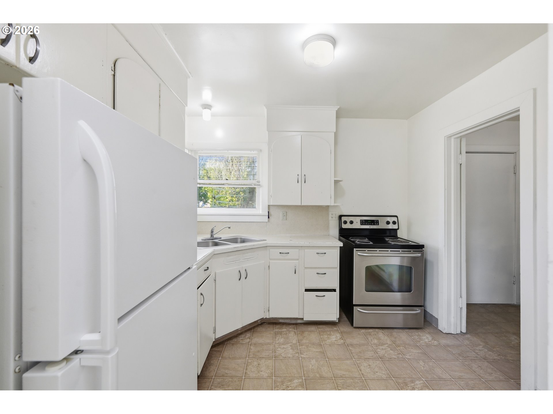 2189 Hilyard Street Eugene, OR 97405 - Photo 12 of 39 a kitchen with stainless steel appliances granite countertop a stove a sink and a refrigerator