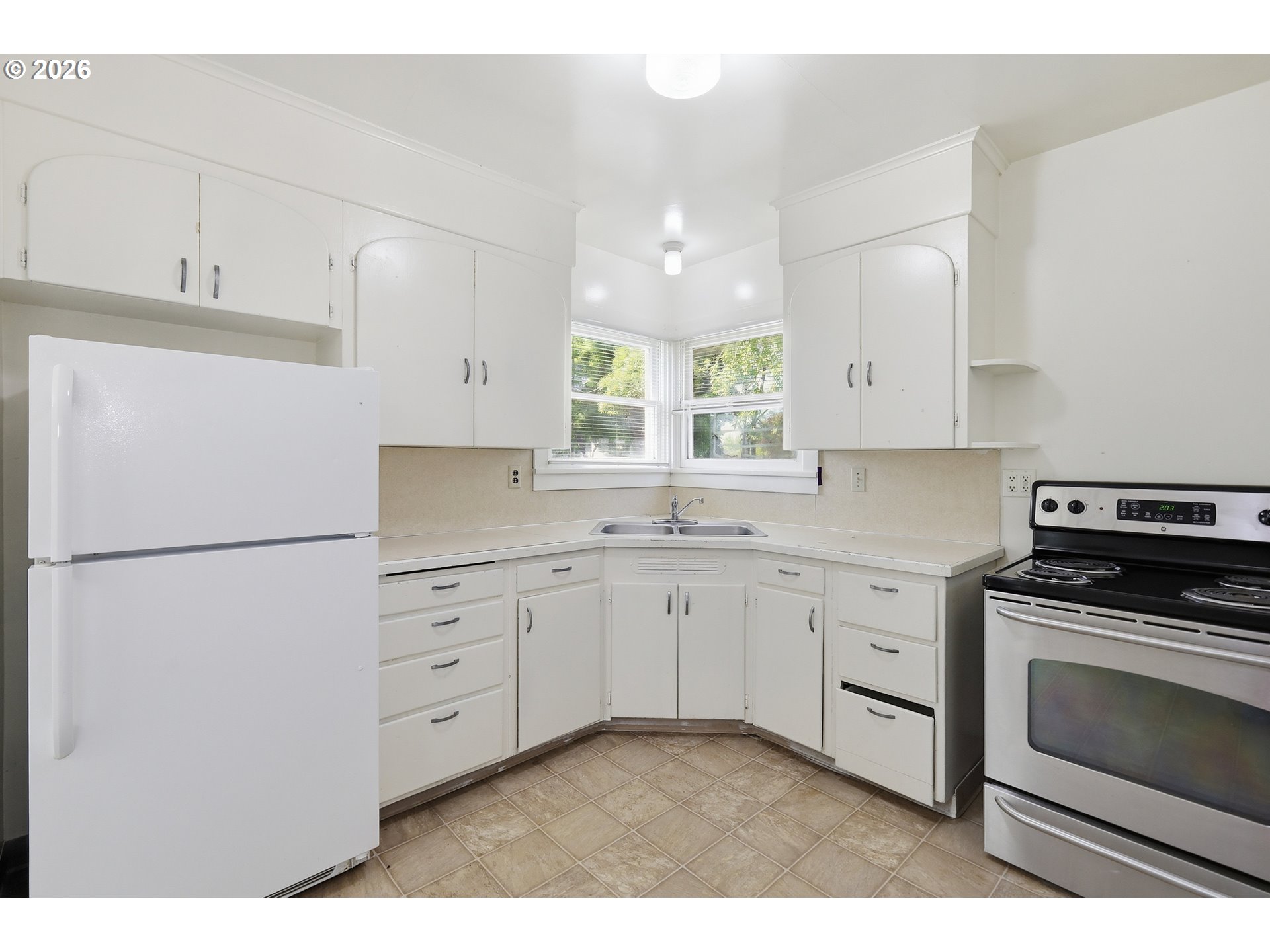 2189 Hilyard Street Eugene, OR 97405 - Photo 13 of 39 a kitchen with granite countertop cabinets appliances a sink and a window