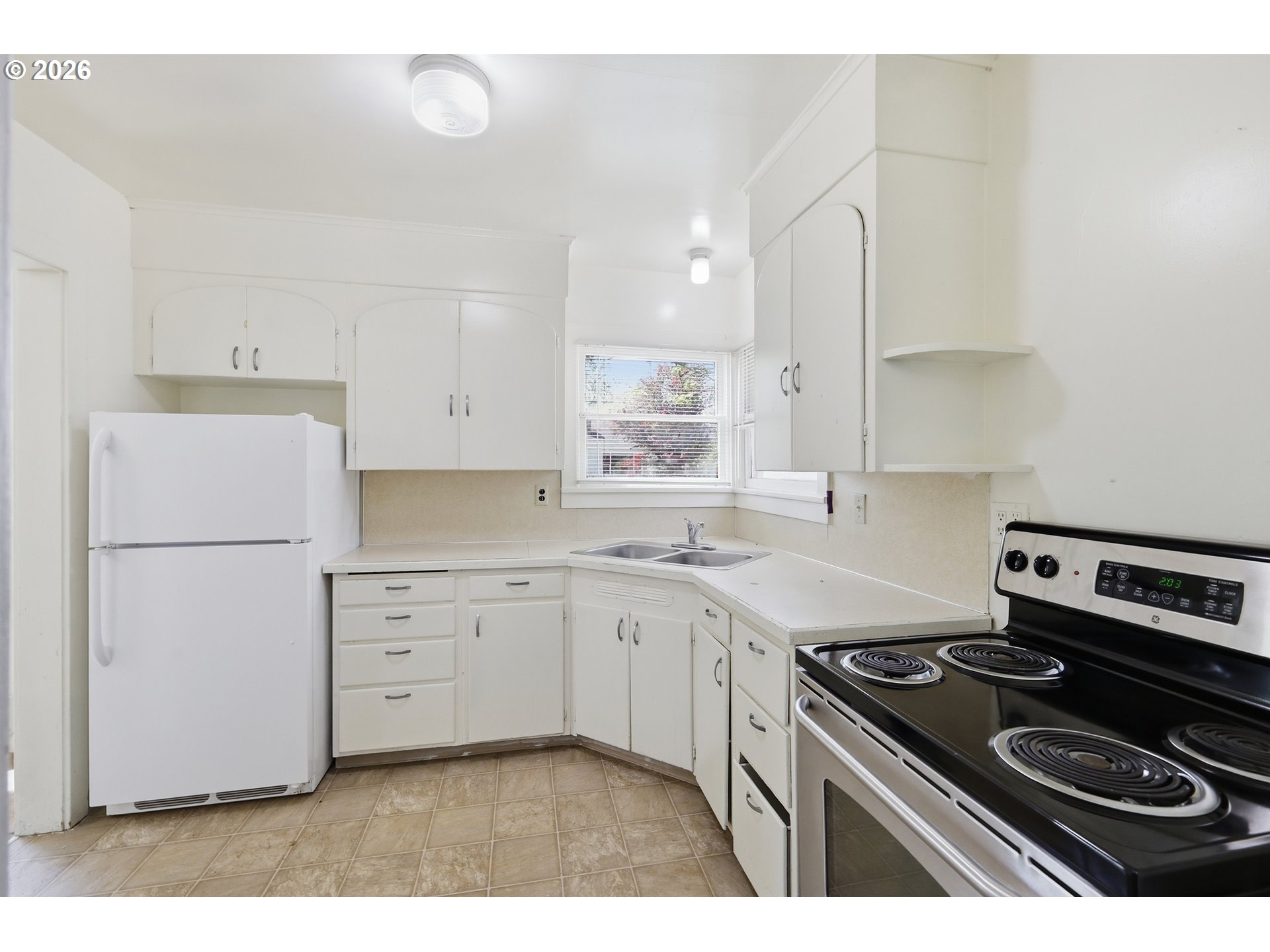 2189 Hilyard Street Eugene, OR 97405 - Photo 14 of 39 a kitchen with a stove a sink and a refrigerator