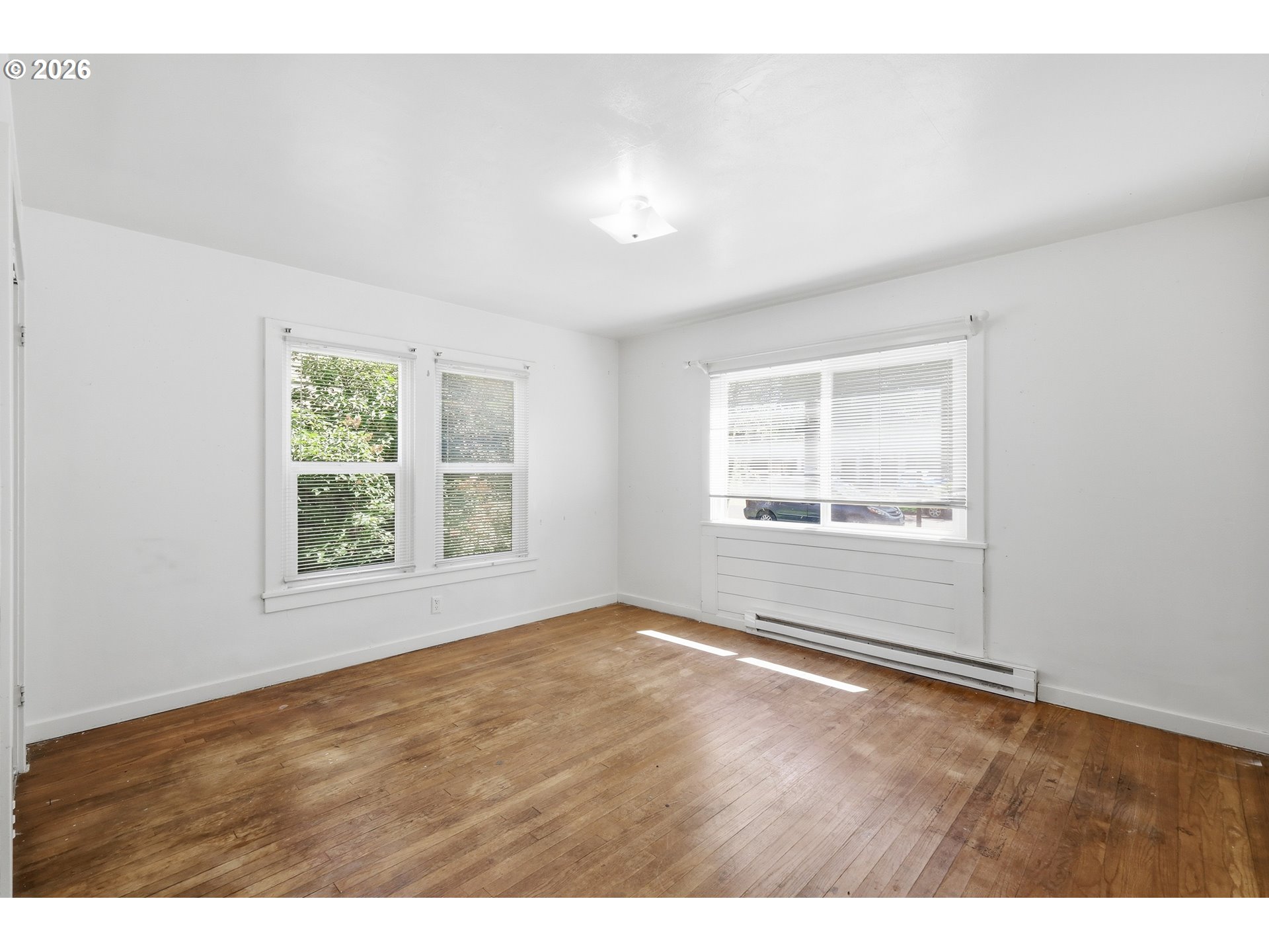 2189 Hilyard Street Eugene, OR 97405 - Photo 20 of 39 a view of an empty room with wooden floor and a window