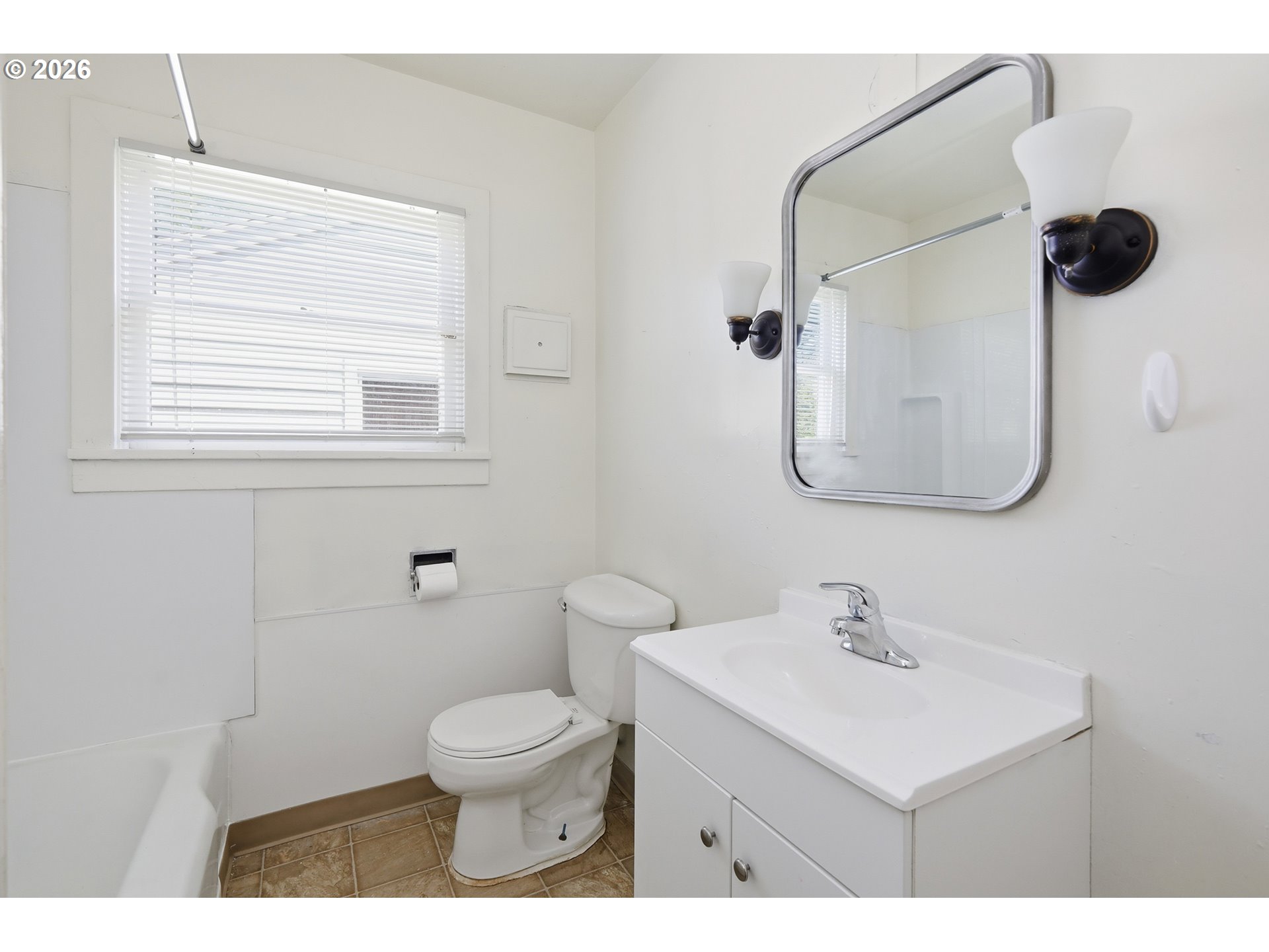 2189 Hilyard Street Eugene, OR 97405 - Photo 22 of 39 a bathroom with a toilet a sink a mirror and vanity