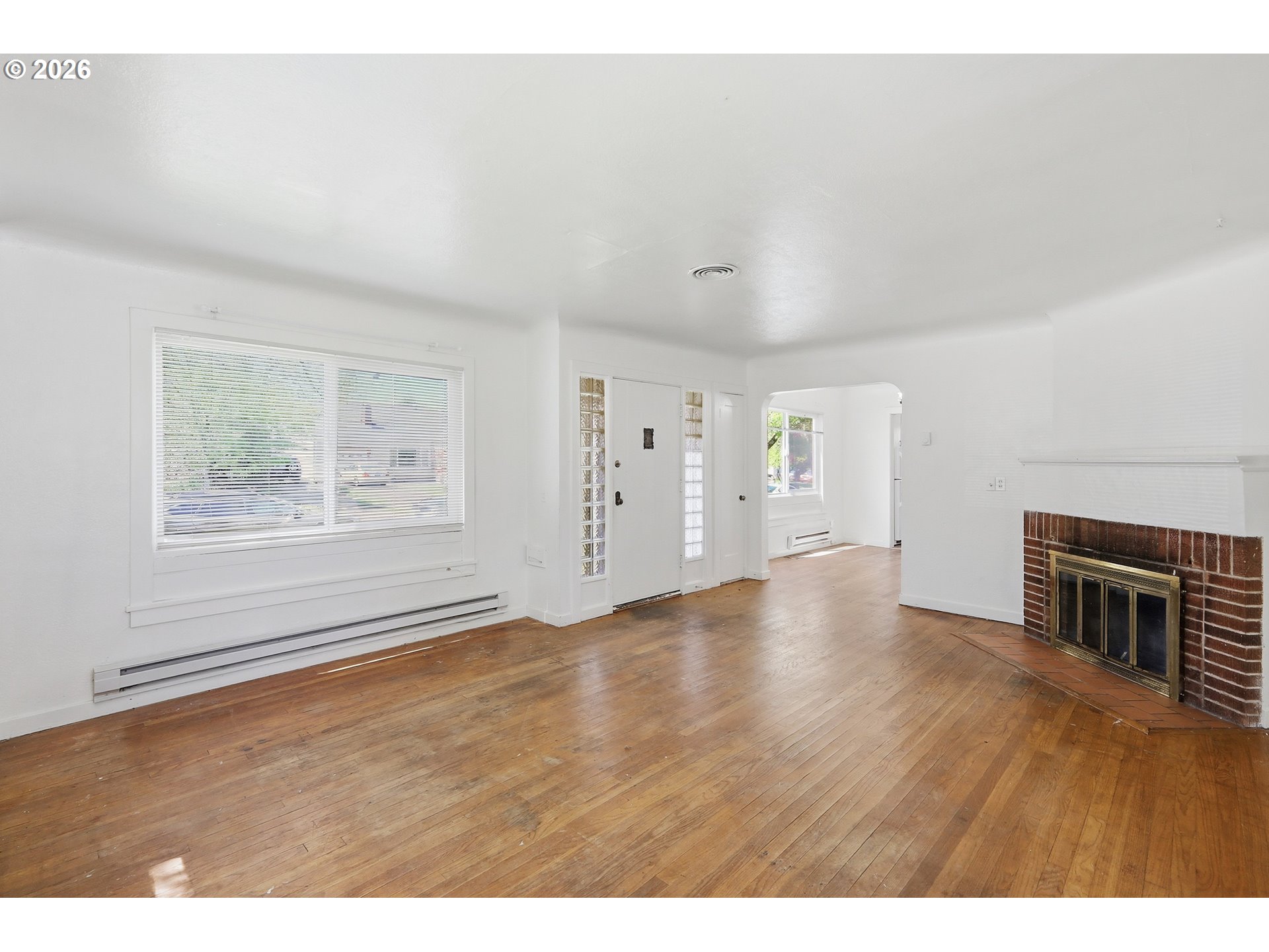 2189 Hilyard Street Eugene, OR 97405 - Photo 3 of 39 a view of an empty room with window and wooden floor
