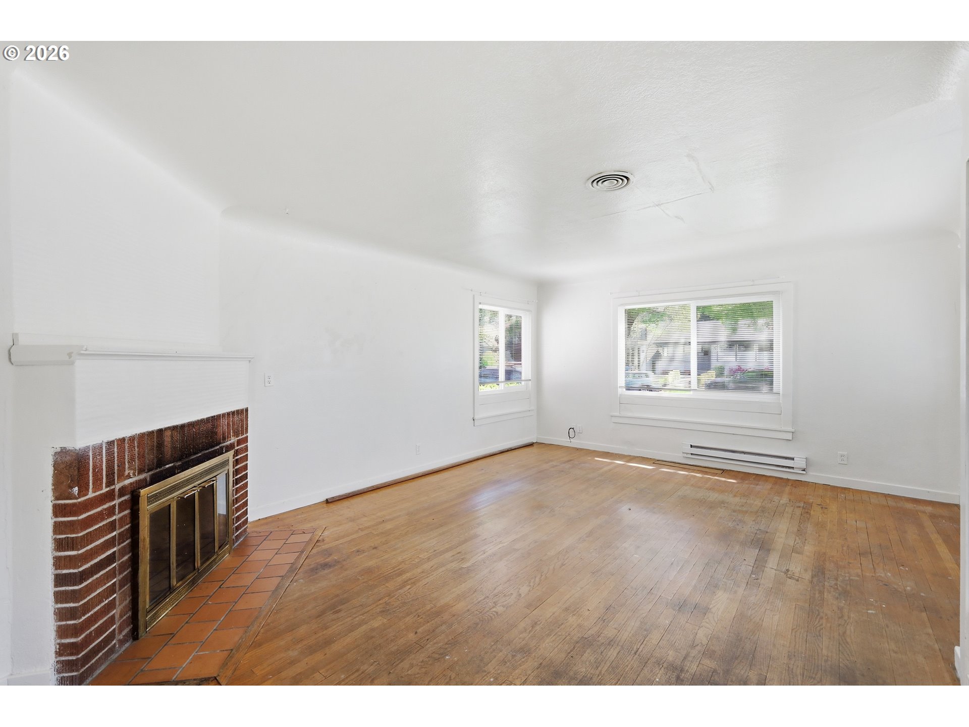 2189 Hilyard Street Eugene, OR 97405 - Photo 5 of 39 a view of an empty room with window and wooden floor