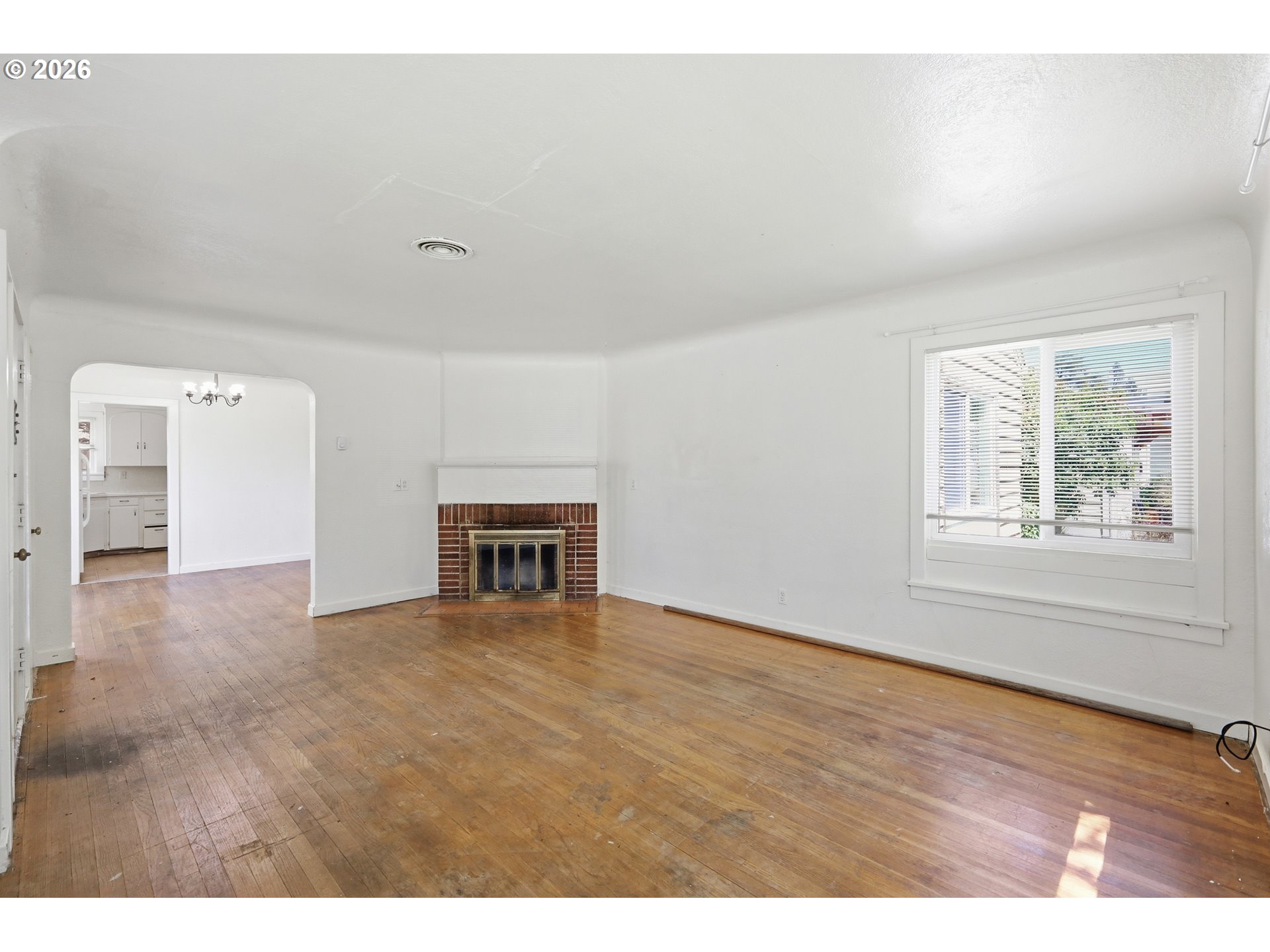 2189 Hilyard Street Eugene, OR 97405 - Photo 6 of 39 a view of an empty room with window and wooden floor
