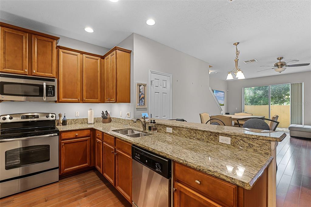 14242 Desert Haven Street, Unit GE Windermere, FL 34786 - Photo 11 of 32 a kitchen with a sink stove top oven and microwave