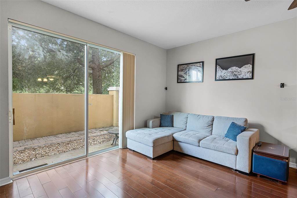 14242 Desert Haven Street, Unit GE Windermere, FL 34786 - Photo 12 of 32 a living room with furniture and a floor to ceiling window