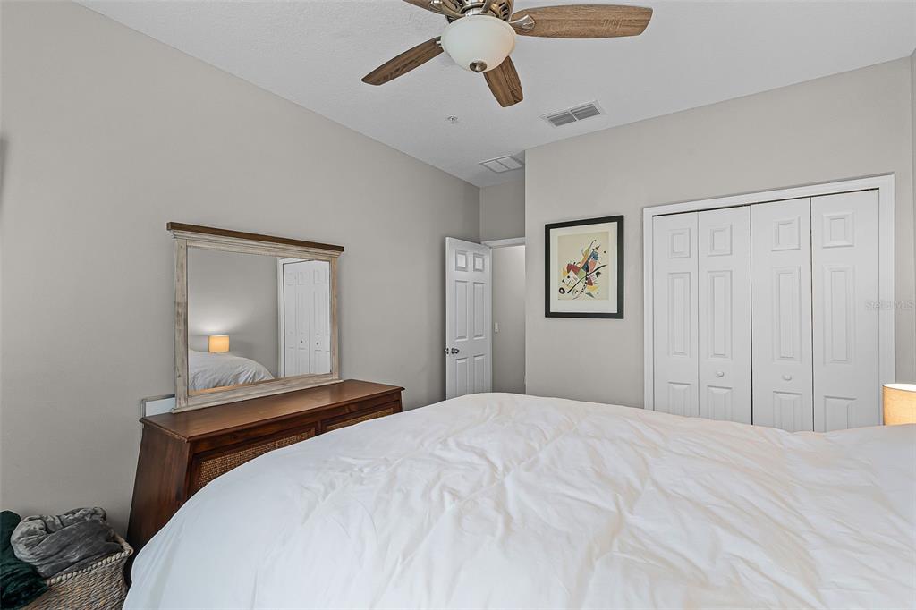 14242 Desert Haven Street, Unit GE Windermere, FL 34786 - Photo 19 of 32 a bedroom with a bed and a chandelier