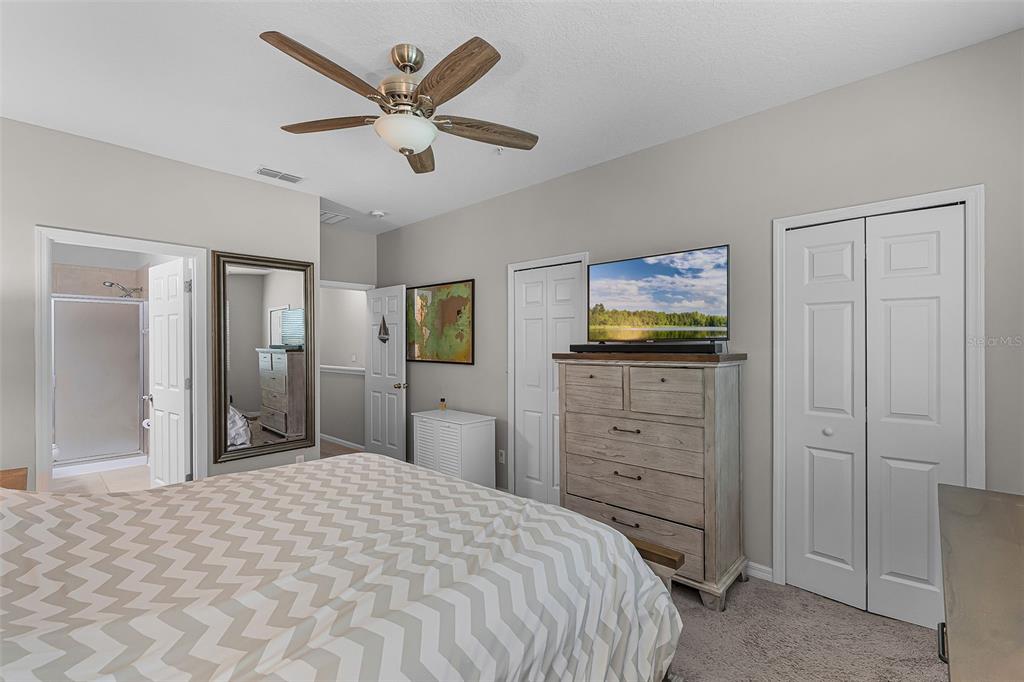 14242 Desert Haven Street, Unit GE Windermere, FL 34786 - Photo 26 of 32 a bedroom with a bed and a dresser