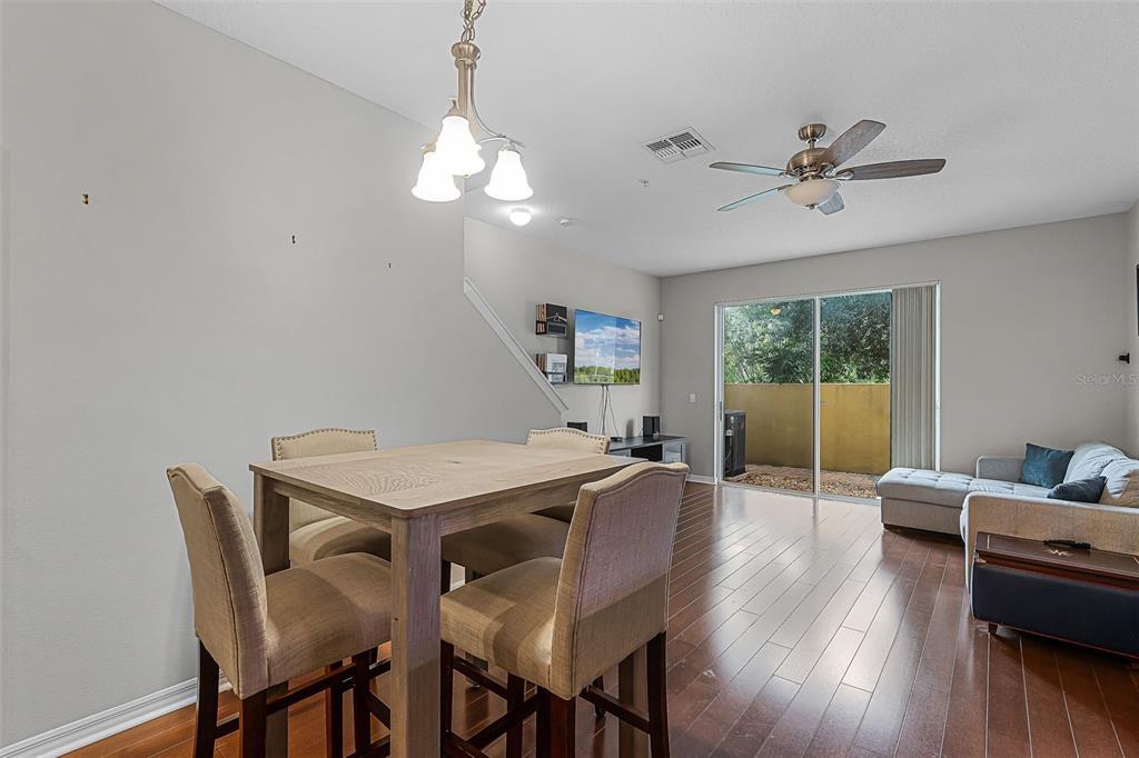 14242 Desert Haven Street, Unit GE Windermere, FL 34786 - Photo 4 of 32 a view of a dining room with furniture window and wooden floor