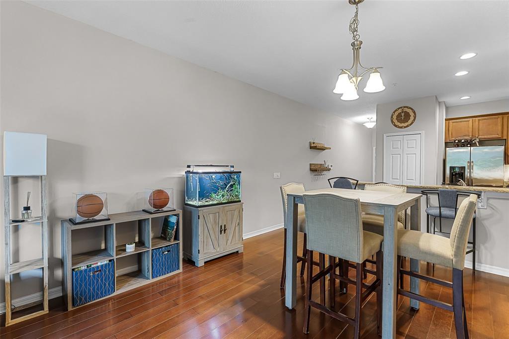 14242 Desert Haven Street, Unit GE Windermere, FL 34786 - Photo 6 of 32 a view of a dining room with furniture kitchen and wooden floor
