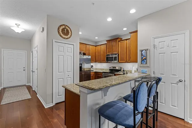 a kitchen with a refrigerator a stove top oven a sink and cabinets