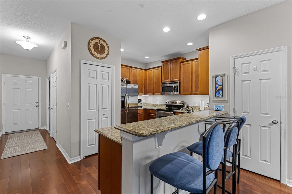 14242 Desert Haven Street, Unit GE Windermere, FL 34786 - Photo 7 of 32 a kitchen with a refrigerator a stove top oven a sink and cabinets