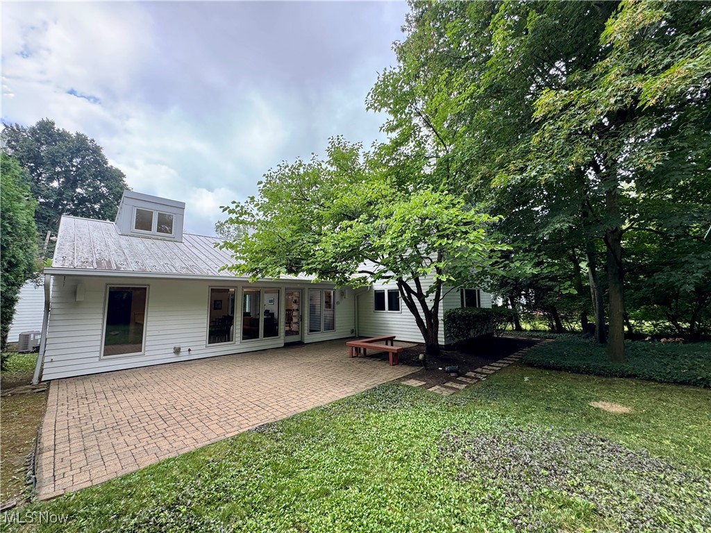 3559 Birchtree Path Cleveland, OH 44121 - Photo 29 of 37 Back of property featuring a lawn, a patio, and a metal roof