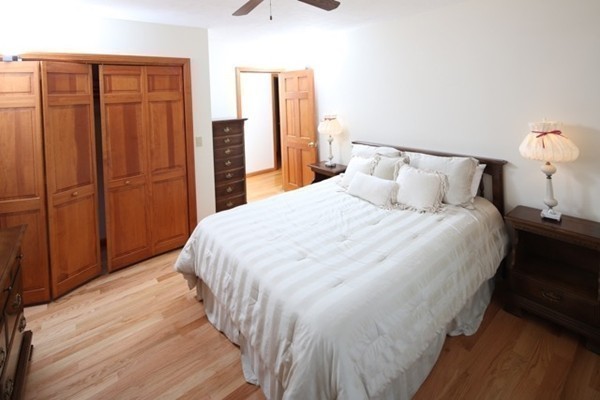 22 Ilex Road Marshfield, MA 02050 - Photo 12 of 21 a large bed in a bedroom next to a cabinet