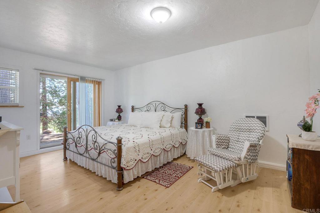 22223 Crestline Road Palomar Mountain, CA 92060 - Photo 47 of 90 a bed room with a bed and a chair