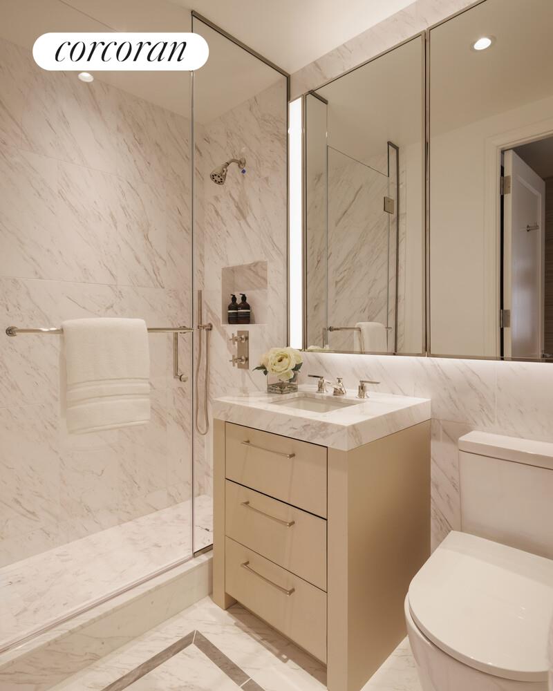 400 East 84th Street, Unit 8F Manhattan, NY 10028 - Photo 5 of 6 a bathroom with a sink a mirror and a shower