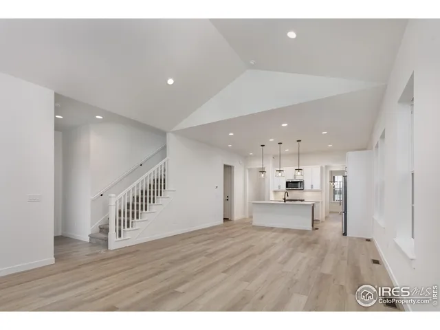 a view of kitchen with refrigerator and window