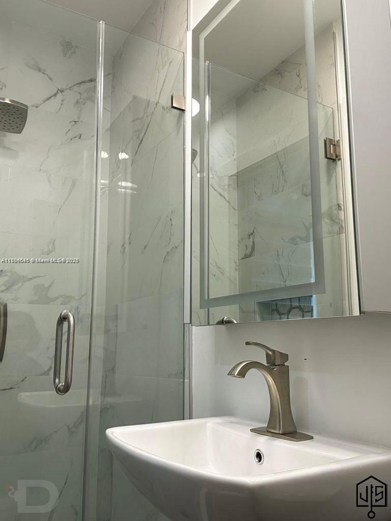 2100 Southwest 100th Avenue, Unit 1 Miami, FL 33165 - Photo 15 of 28 a bathroom with a sink and shower