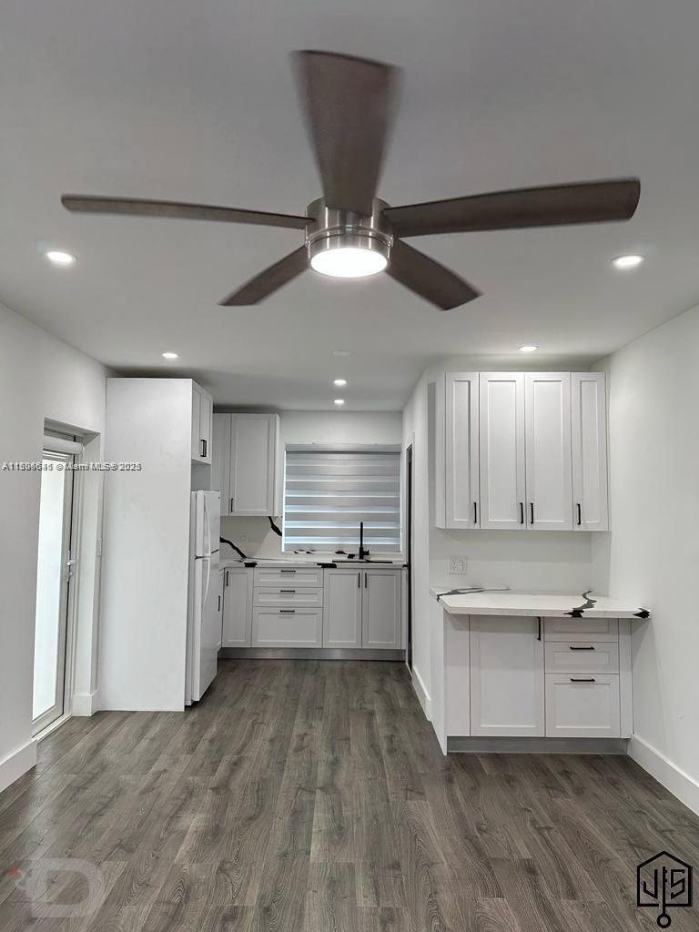 2100 Southwest 100th Avenue, Unit 1 Miami, FL 33165 - Photo 2 of 28 a kitchen with a refrigerator and white cabinets