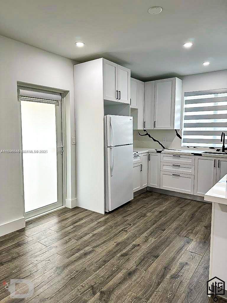 2100 Southwest 100th Avenue, Unit 1 Miami, FL 33165 - Photo 4 of 28 a kitchen with granite countertop white cabinets and wooden floor