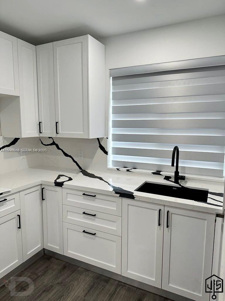 2100 Southwest 100th Avenue, Unit 1 Miami, FL 33165 - Photo 6 of 28 a kitchen with granite countertop white cabinets and sink