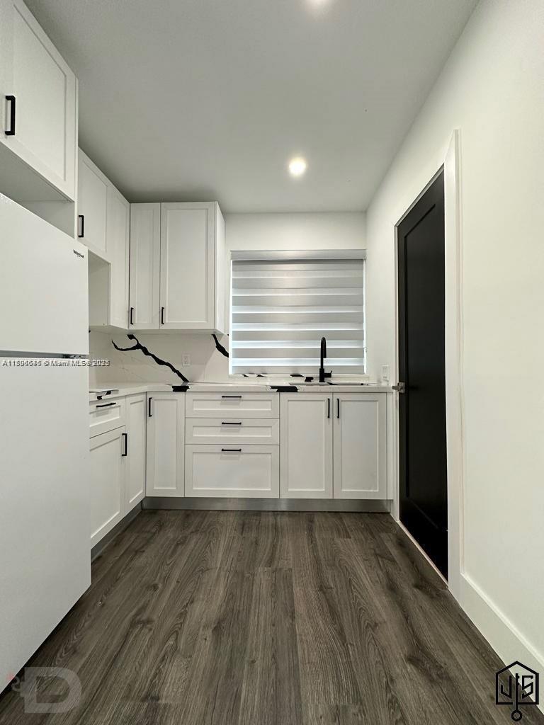2100 Southwest 100th Avenue, Unit 1 Miami, FL 33165 - Photo 8 of 28 a kitchen with granite countertop white cabinets and white appliances