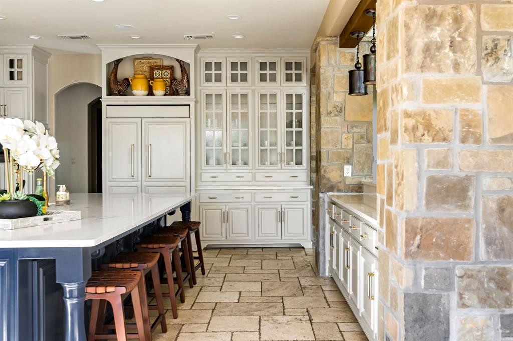 9930 Boat Club Road Fort Worth, TX 76179 - Photo 14 of 40 The main house kitchen offers elegant finishes, a large island, and premium appliances designed for both style and function.
