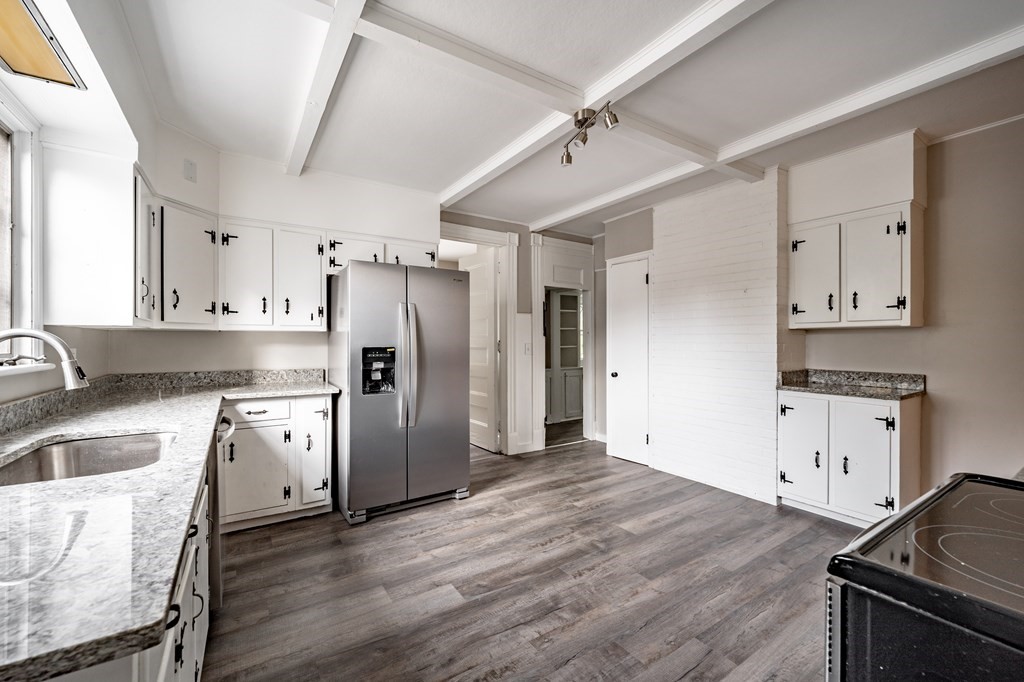 110 Mill Street Springfield, MA 01108 - Photo 15 of 41 a kitchen with granite countertop a refrigerator stove and sink