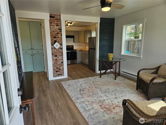 a living room with furniture and a dresser